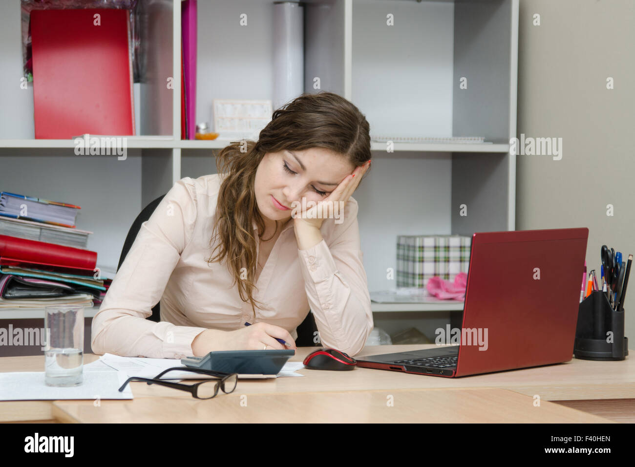 Girl sleeping on a workplace at office Stock Photo
