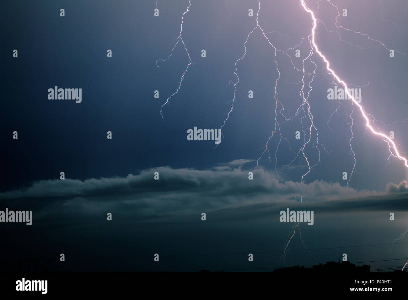 Bolt of lightning so bright it appears to be in a clear blue sky ...