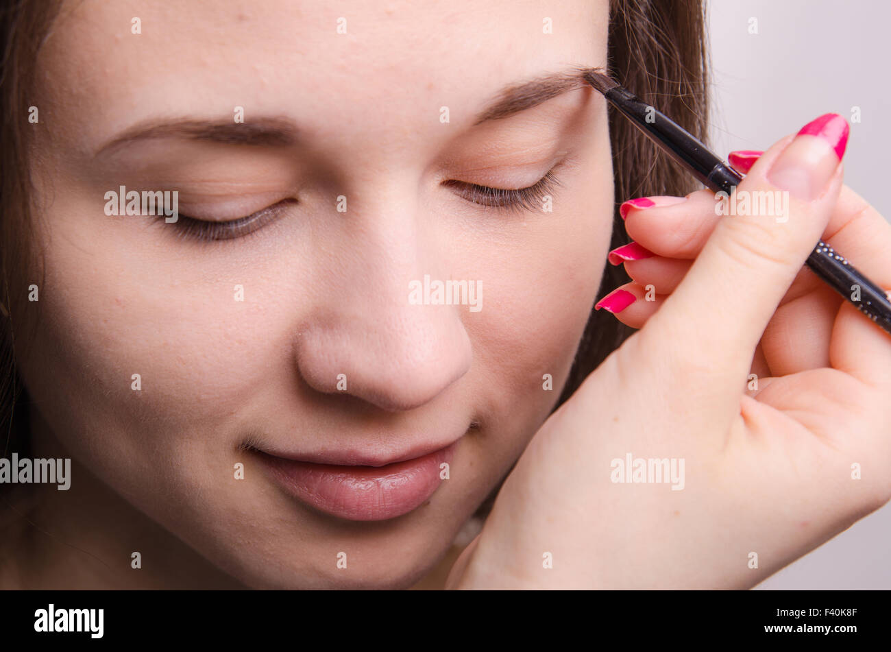 Makeup artist brings eyebrow brush model Stock Photo