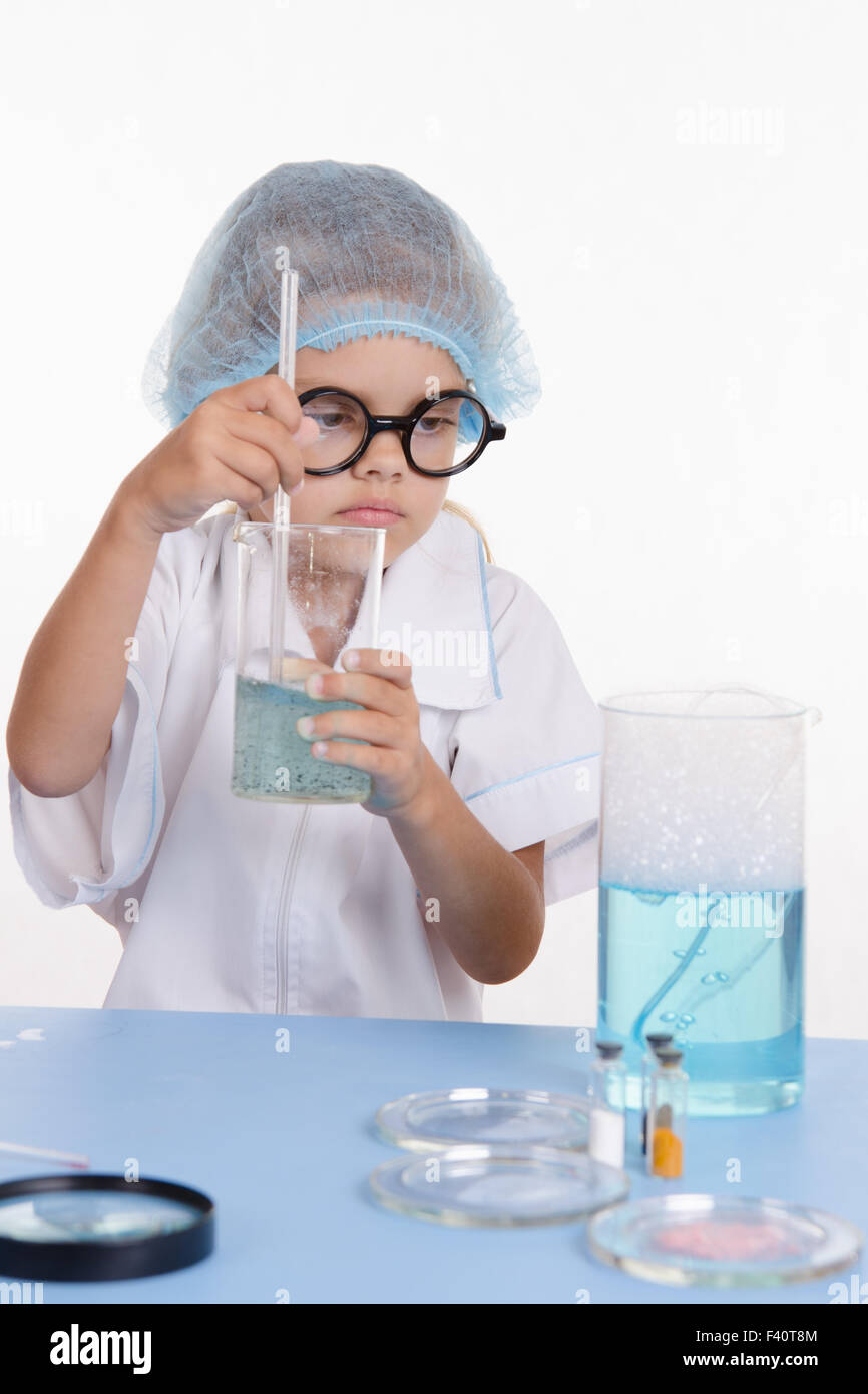 Girl chemist mixes the contents of flasks Stock Photo