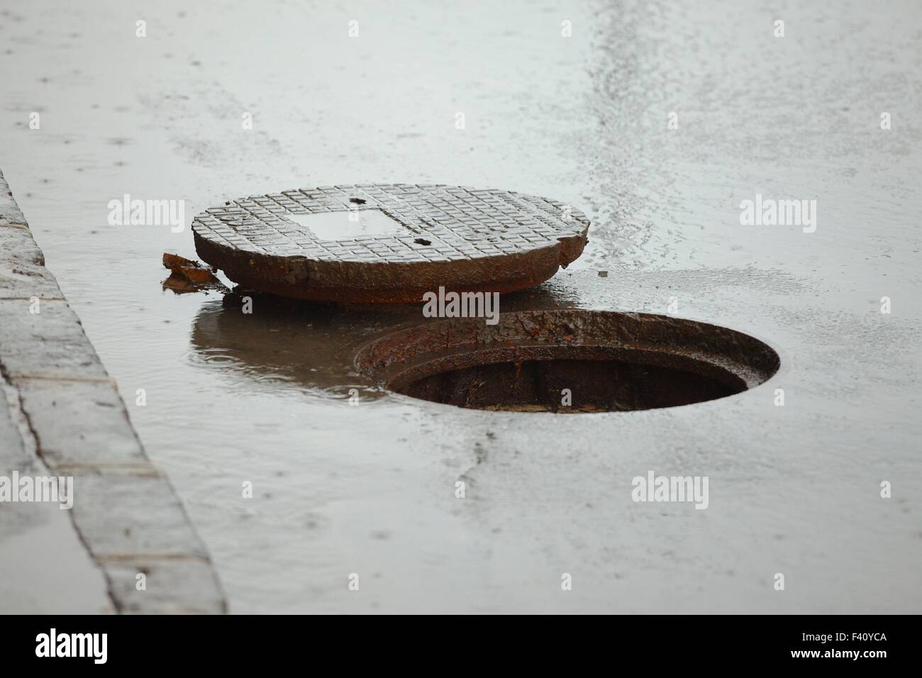 Sewer cover open Stock Photo - Alamy