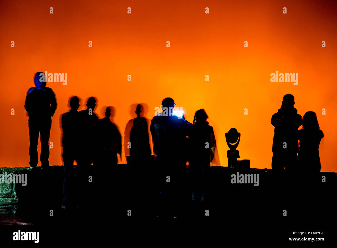 Visitors in silhouette at dusk, lava glowing Kilaueea Caldera volcano, Hawai'i Volcanoes National Park, Big Island, Hawaii, USA Stock Photo