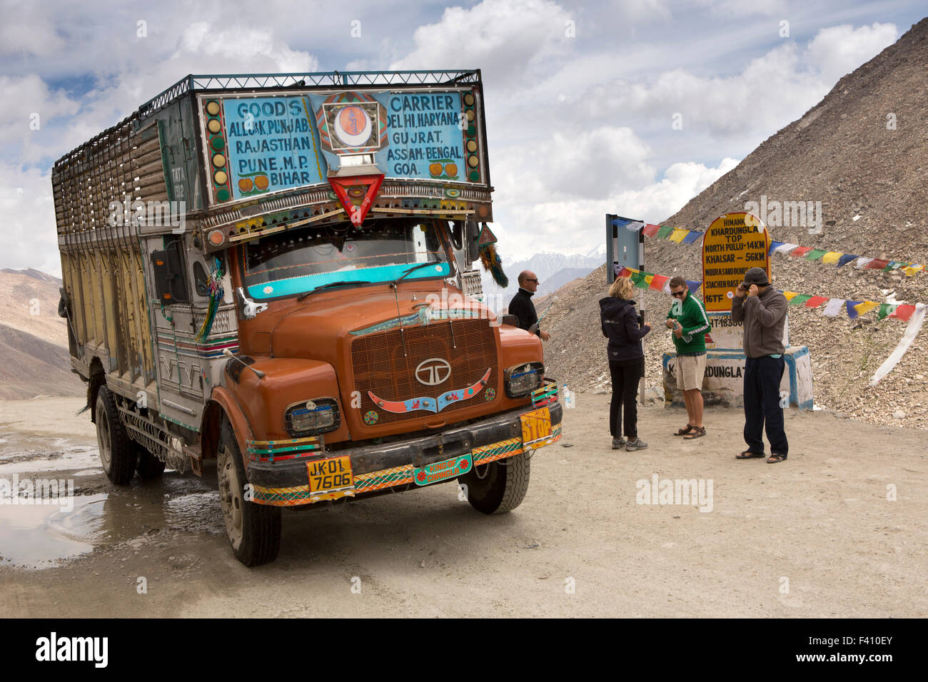 India, Jammu & Kashmir, Ladakh, Leh, Khardung La Pass top, truck passing tourists at summit marker stone Stock Photo