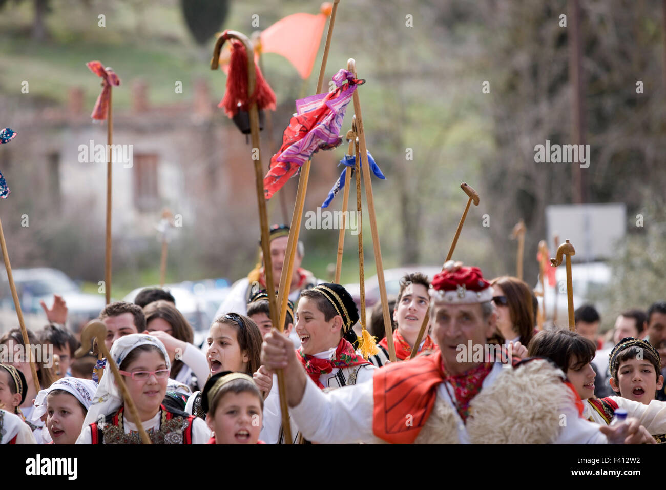 A sham leads Greek vlach wedding dancers team who bawl on their way to the shepherd's shack, raising their rods. Thivai, Greece Stock Photo