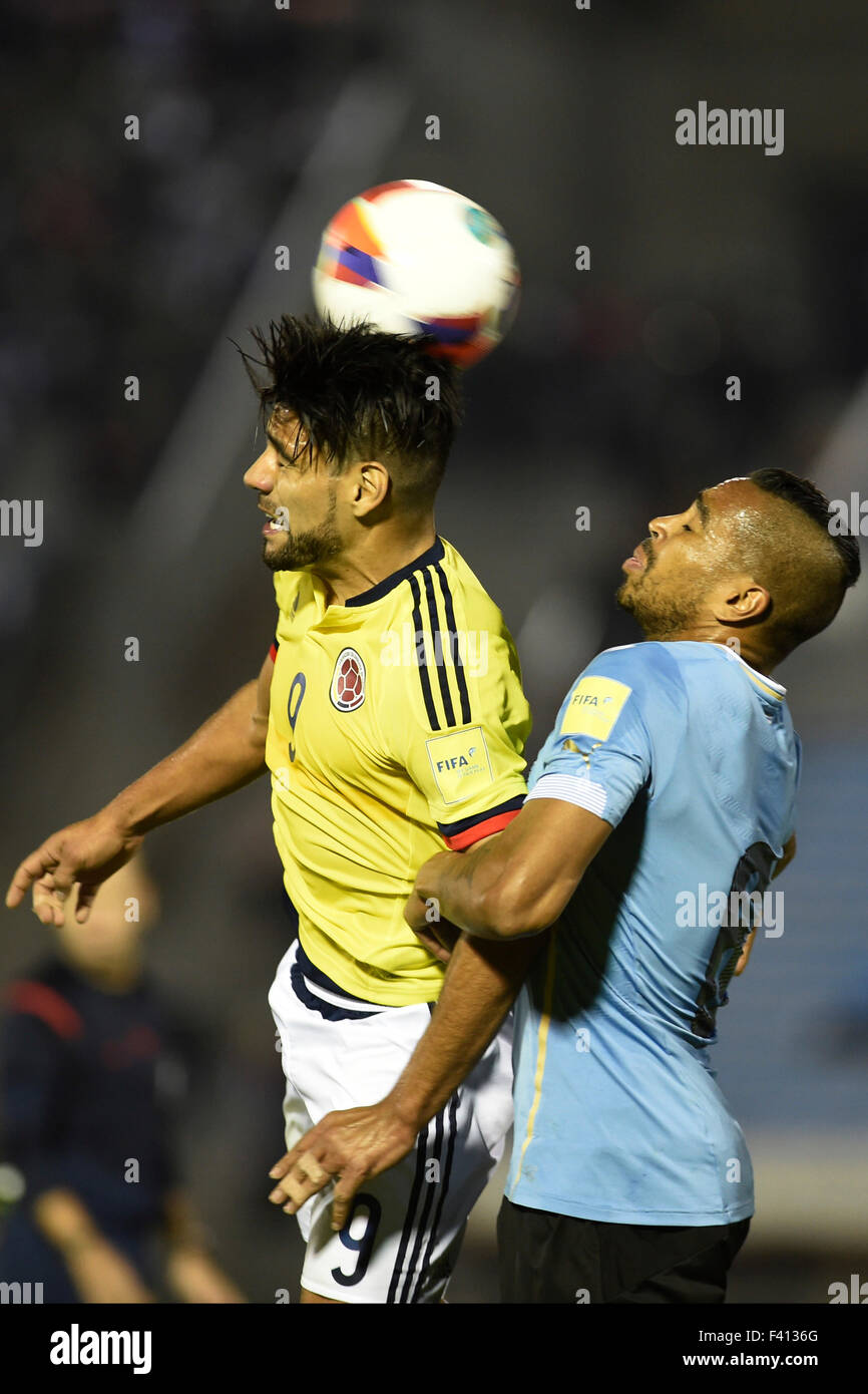 Montevideo, Uruguay. 13th Oct, 2015. Alvaro Pereira(R) of Uruguay heads the ball with Falcao Garcia of Colombia during their Round 1 Group 1 match of 2018 World Cup South American Qualifiers at the Centenario stadium in Montevideo, capital of Uruguay, on Oct. 13, 2015. Uruguay won 3-0. Credit:  Nicolas Celaya/Xinhua/Alamy Live News Stock Photo
