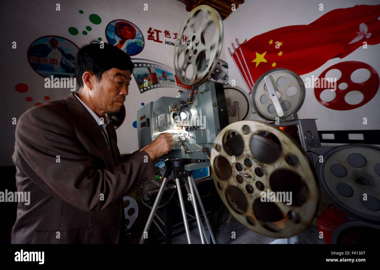 Shijiazhuang, China's Hebei Province. 13th Oct, 2015. Wei Shaoxian operates a film projector at his film museum in Siliugu Village of Handan County, north China's Hebei Province, Oct. 13, 2015. Cinephile Wei Shaoxian collected more than 20,000 items about film, such as filmstrip, poster and record, since 2004 and founded his private film museum in his village in 2015. © Wang Xiao/Xinhua/Alamy Live News Stock Photo