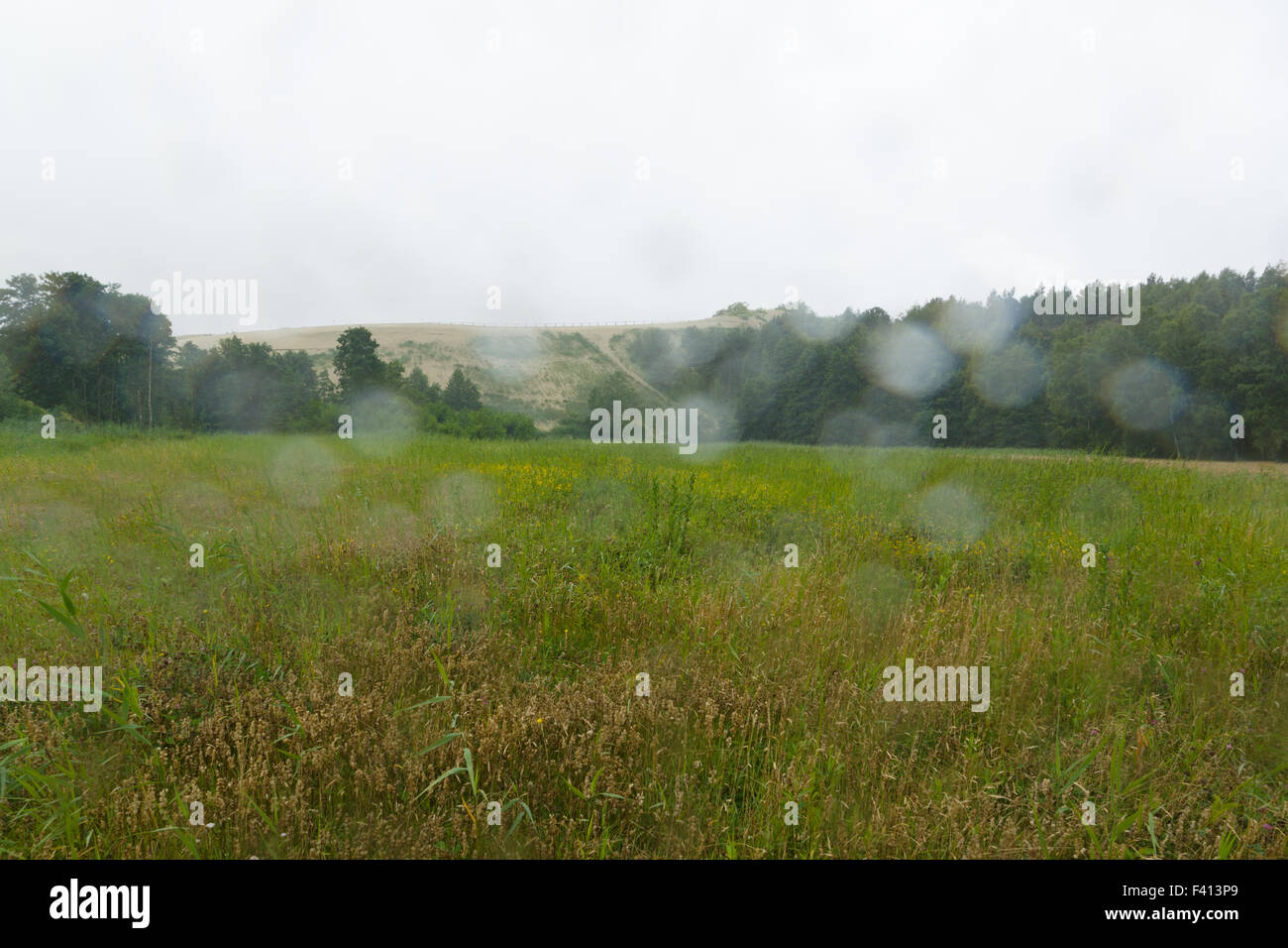 view of a hilly landscape through glass with rain drops Stock Photo - Alamy