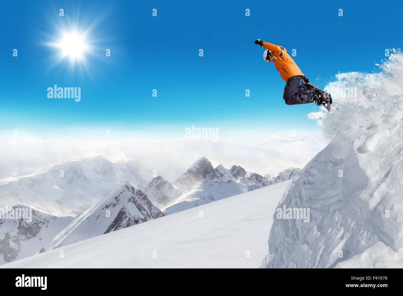 Jumping snowboarder at jump Stock Photo