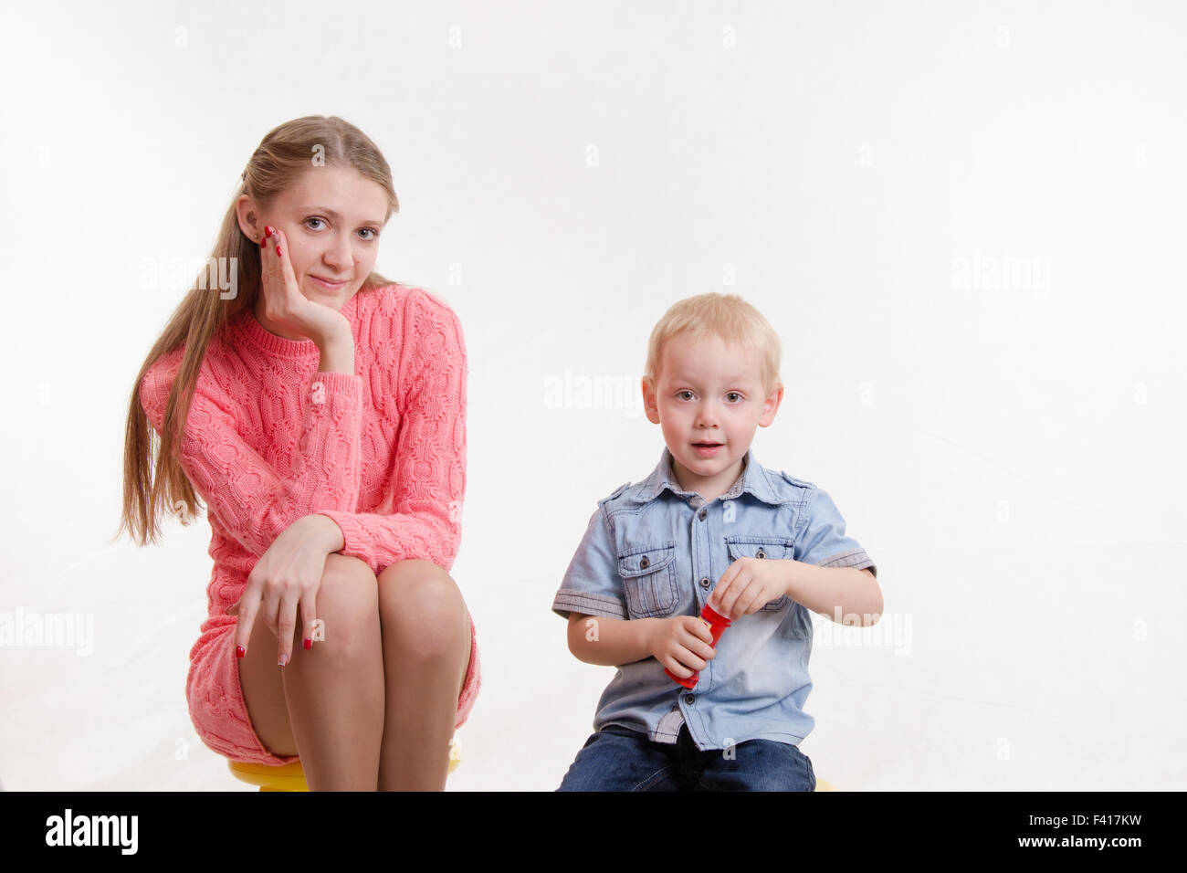 Mom and son blow bubbles Stock Photo