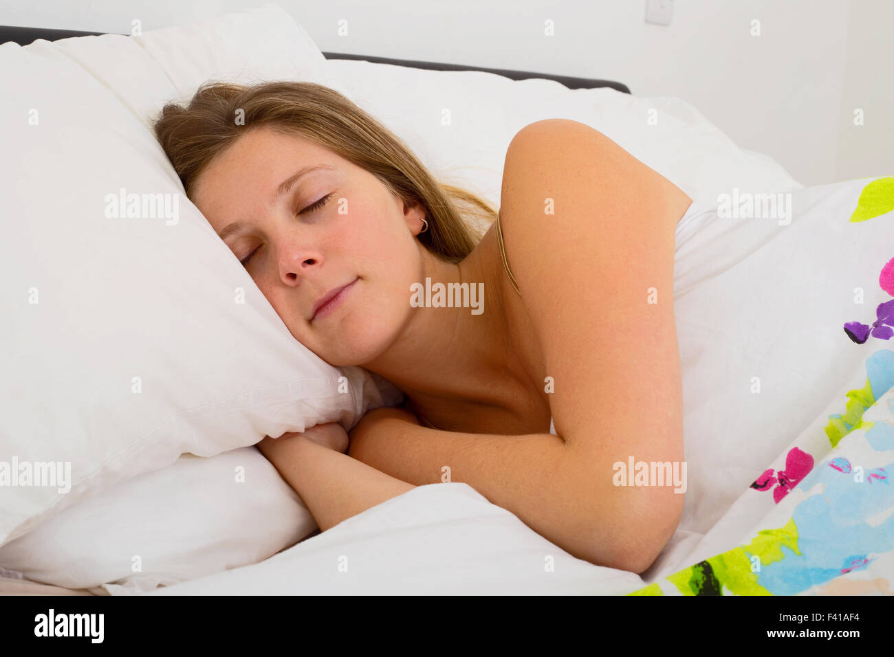young woman asleep in bed Stock Photo