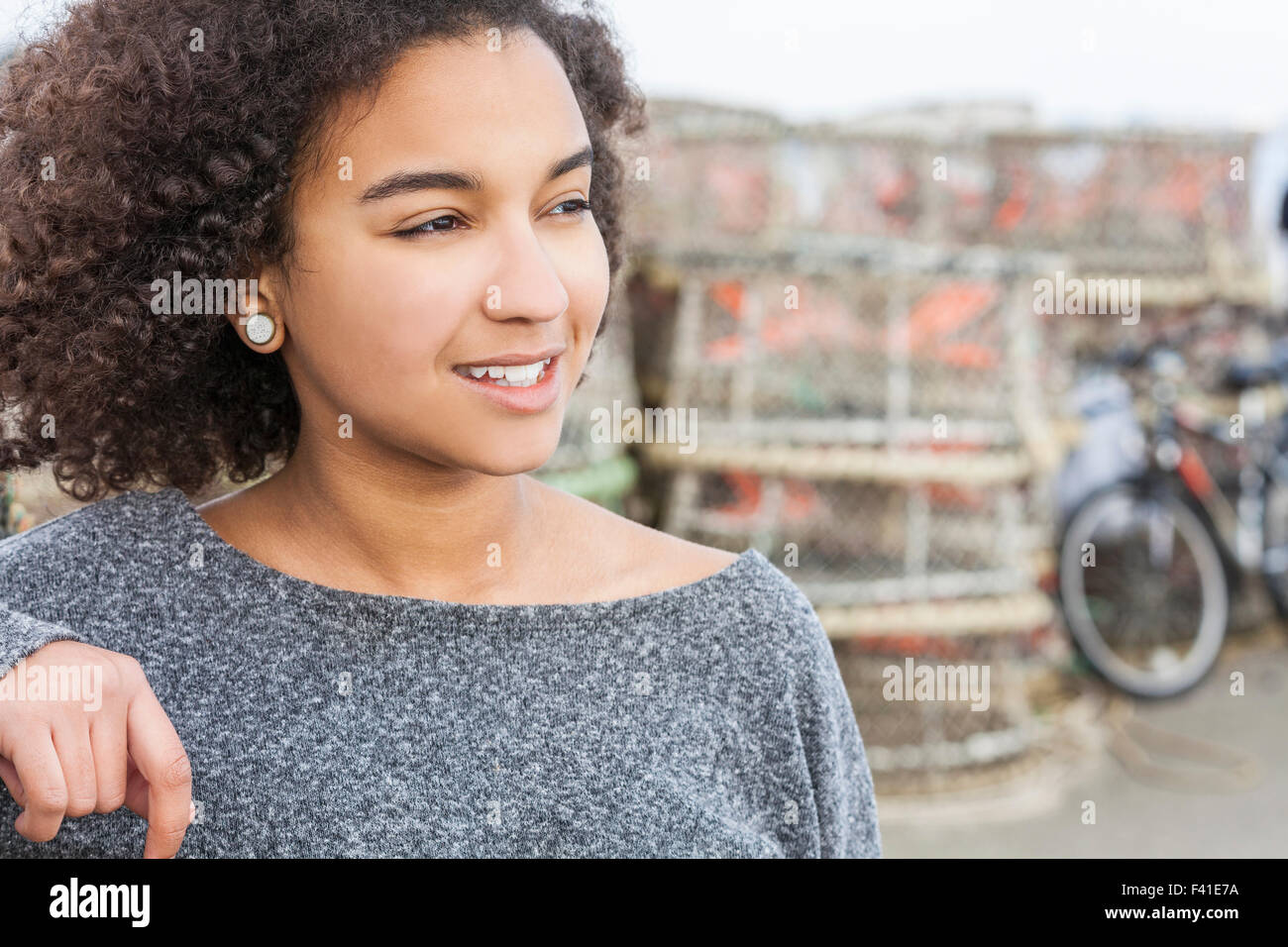 Portrait of happy African American teen girl looking at camera at home,  headshot of smiling black teenager posing indoors, beautiful mixed race  teenage female laughing making picture Stock Photo