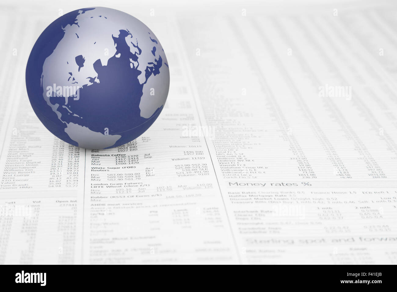 Map of the world globe on a News paper Stock market financial page showing stocks and shares Stock Photo