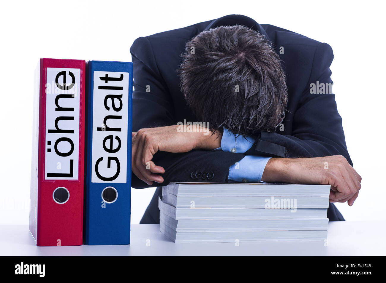 Exhausted businessman at desk Stock Photo