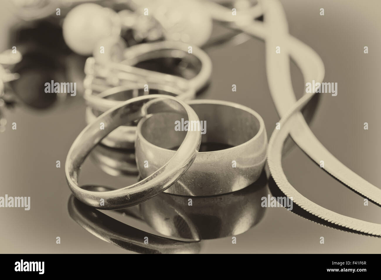 gold wedding rings, earrings and chains Stock Photo Alamy