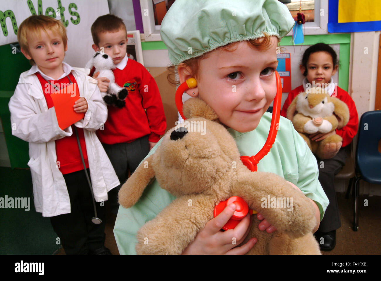 Infant school pupils role playing using role play zones as Chinese restaurant, lighthouse keeper and hospitals and doctors at Carlton Infant School Stock Photo