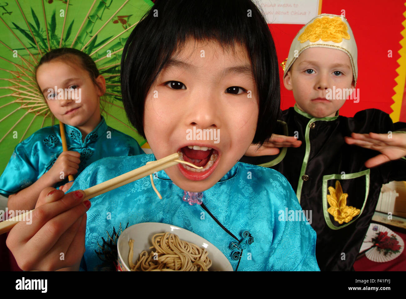 Infant school pupils role playing using role play zones as Chinese restaurant, lighthouse keeper