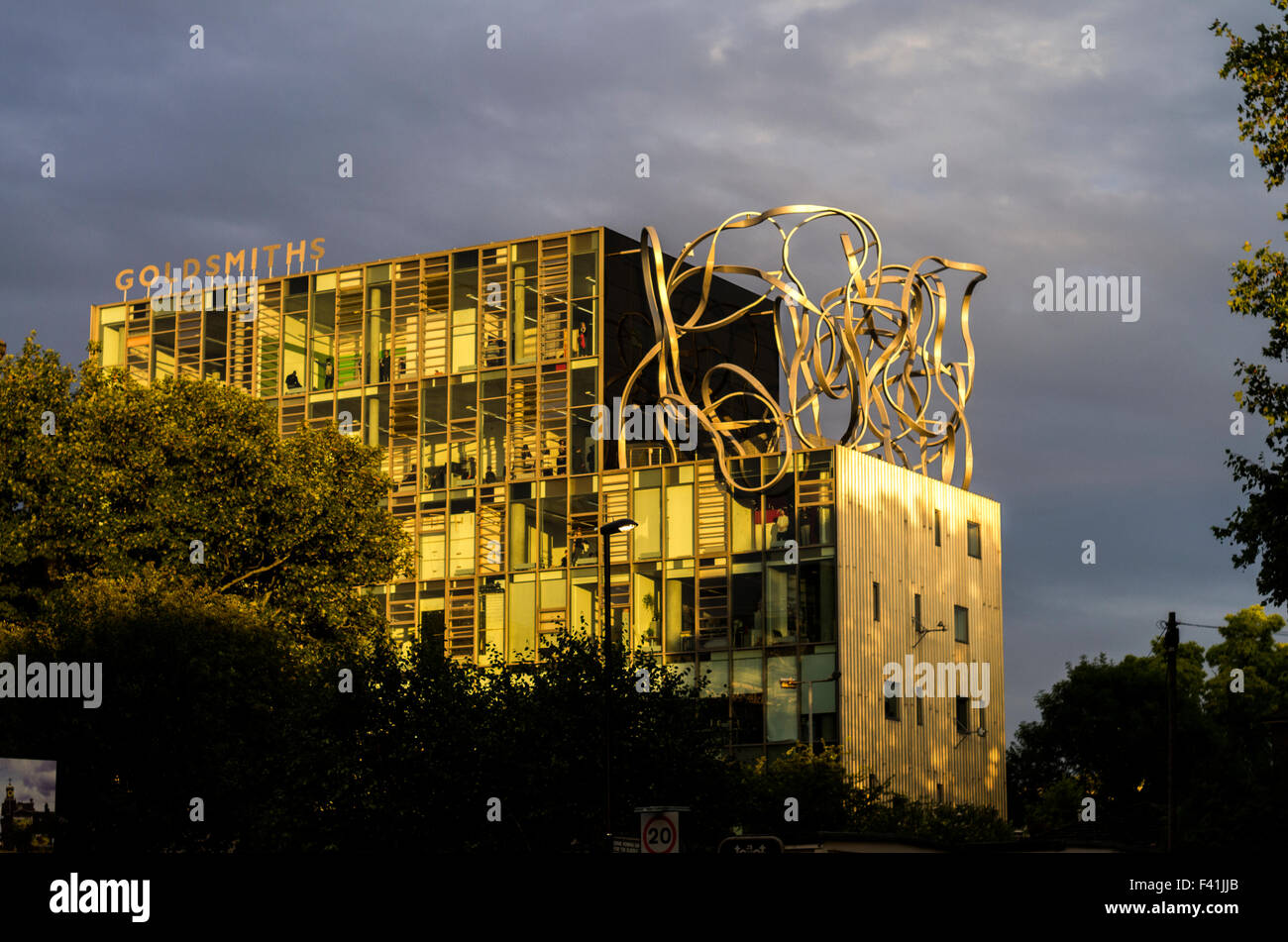 Goldsmiths, University of London, in New Cross, London bathed in dramatic yellow sunlight with a cloudy sky. Stock Photo