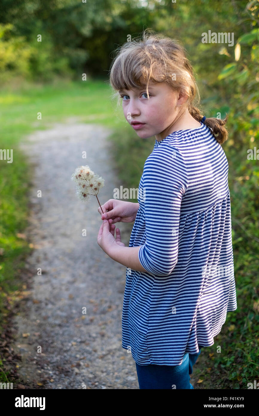 11 year old girl looking thoughtful in the woods Stock Photo