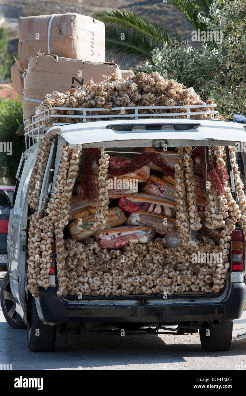 Pile of dried hanging garlic cloves for sale among packs of blankets on a  gypsy peddler's van Stock Photo - Alamy