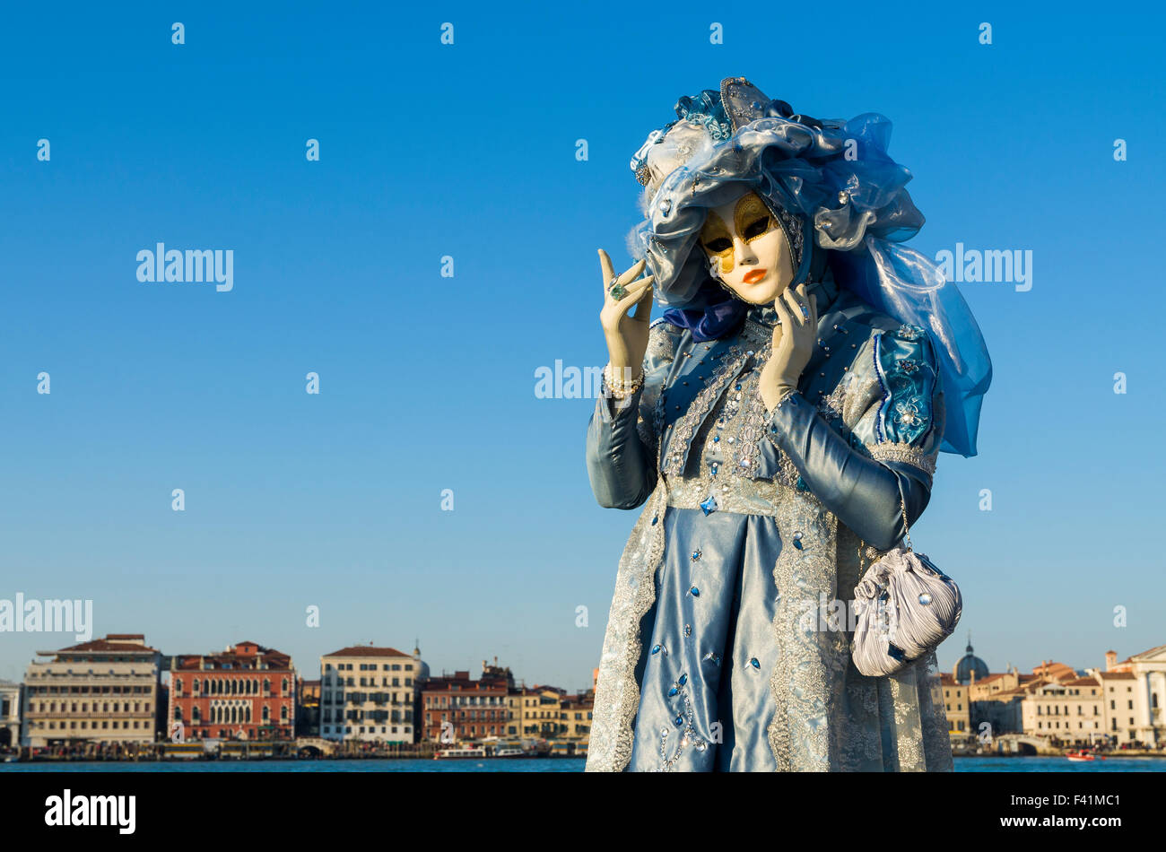 People are wearing imaginative venetian masks during the Carnevale Stock Photo