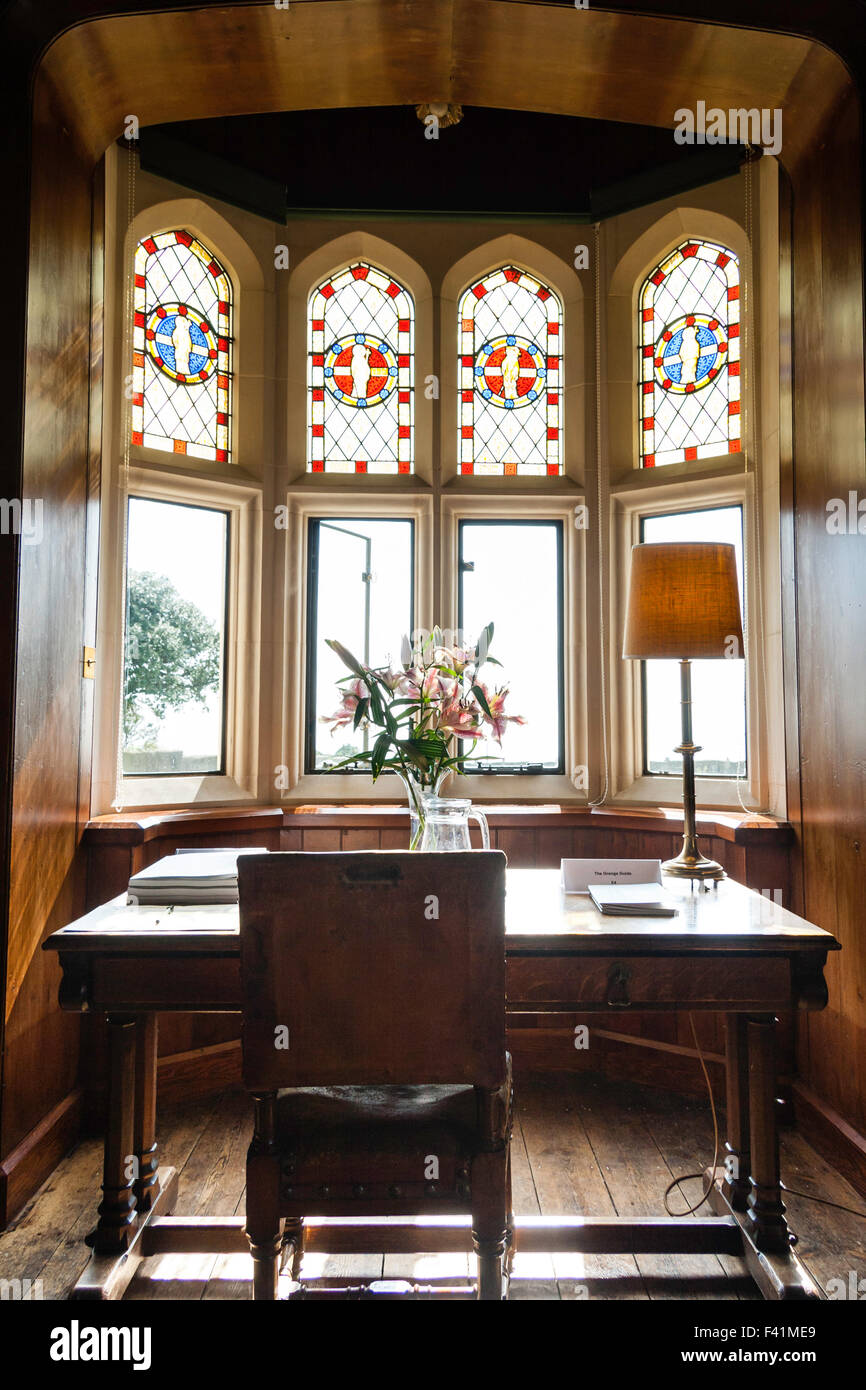 England, Ramsgate. The Grange, house designed by Augustus Pugin. The library with study desk facing the sunlit stained glass bay window. Stock Photo