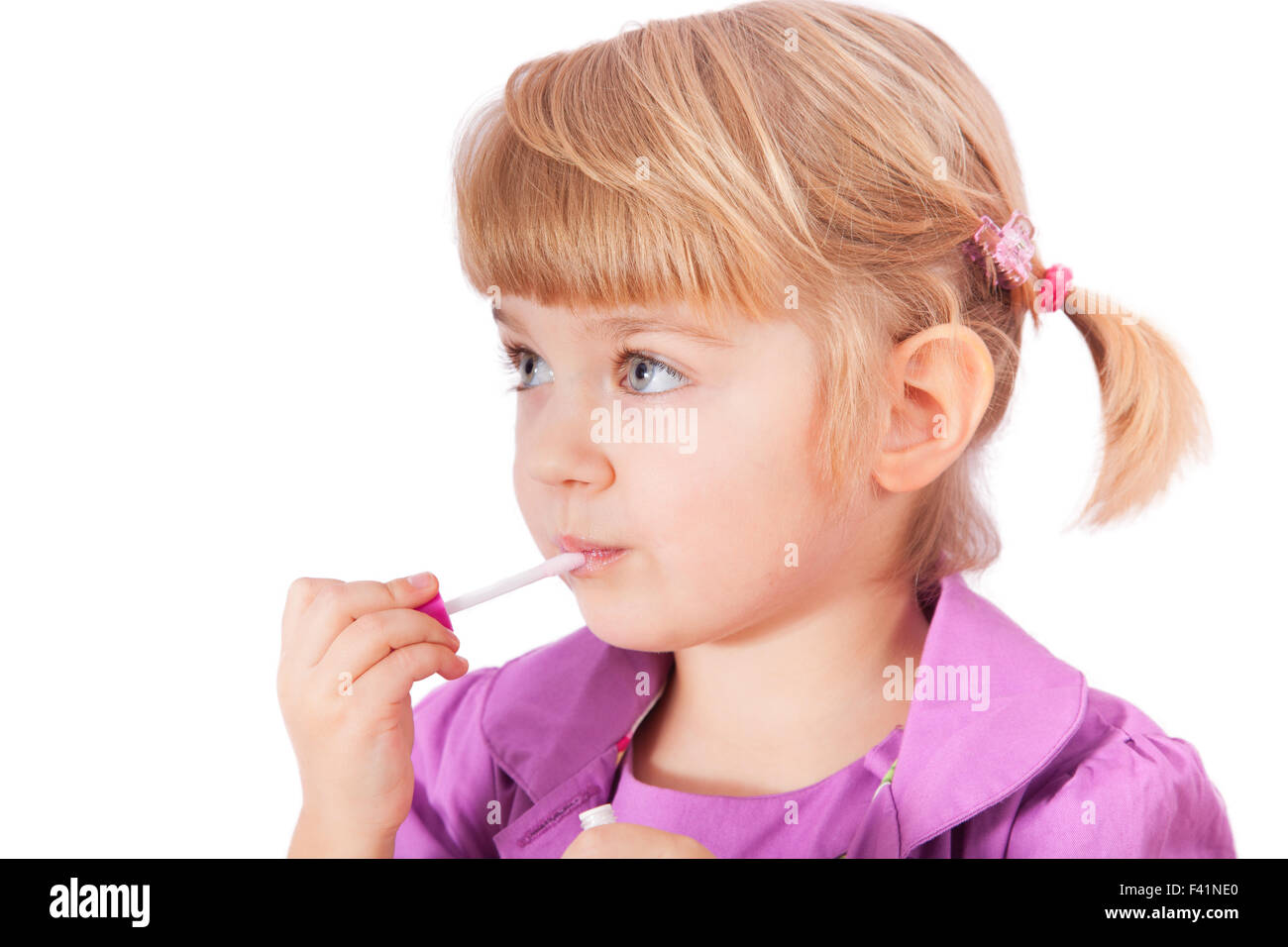 Small girl with lipstick isolated on white Stock Photo