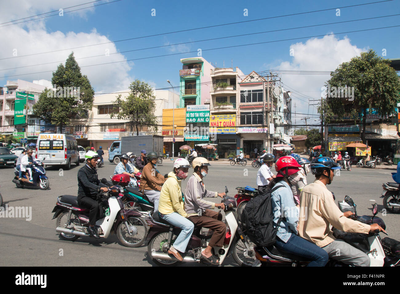 commuters travel on their scooters and motorbikes through Ho Chi Minh