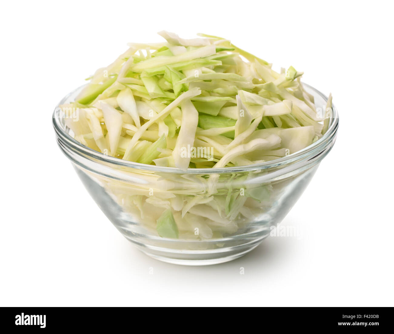 Glass bowl of fresh shredded cabbage isolated on white Stock Photo