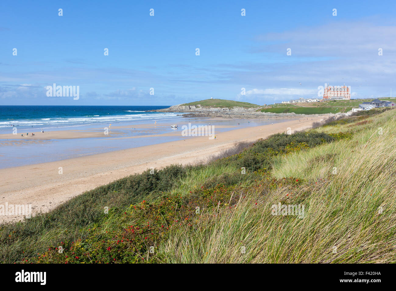 Wide view of Fistral Beach in Newquay, Cornwall viewed from the grassy dunes on a clear, sunny day. Stock Photo