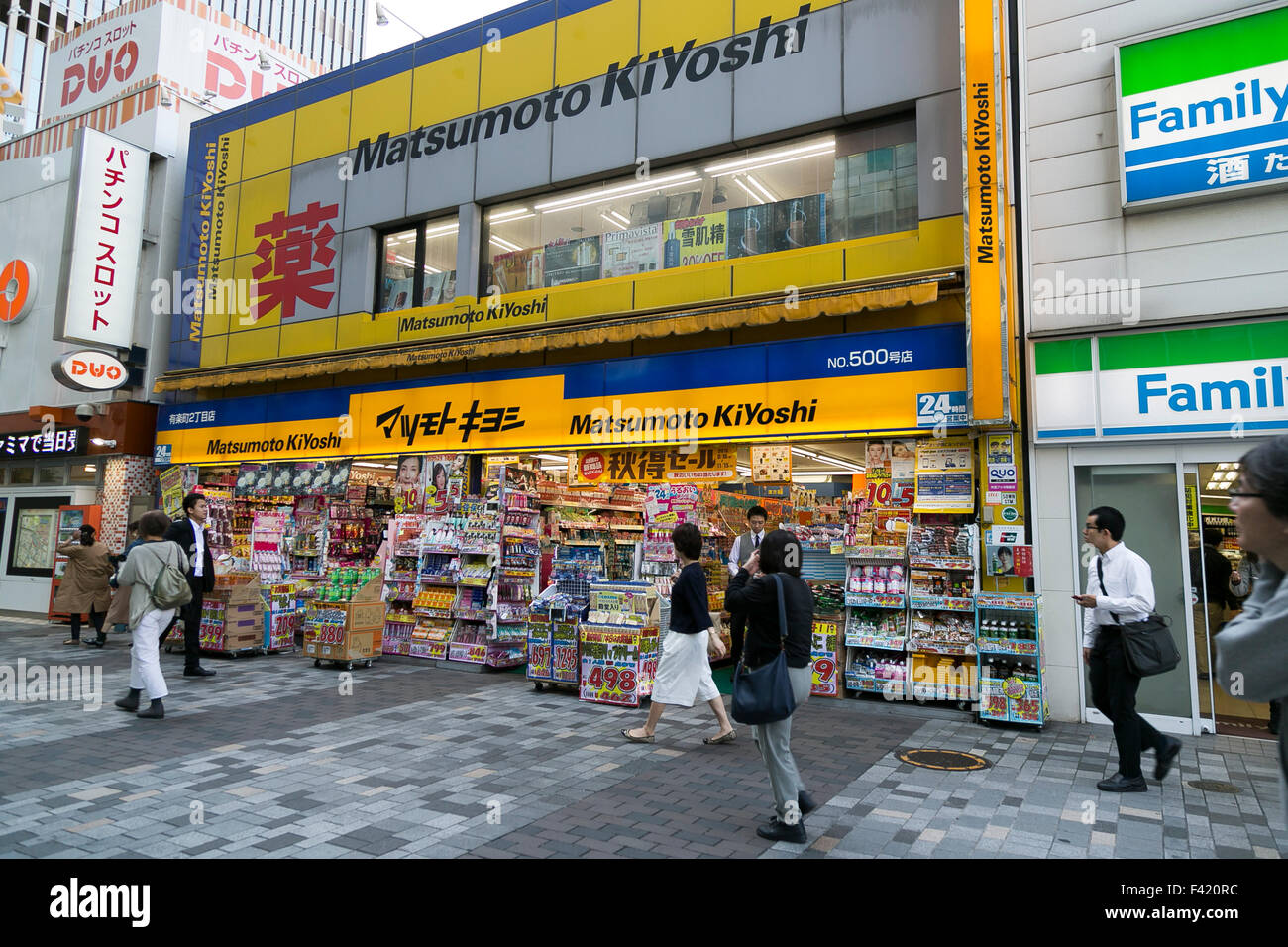 Pedestrians walk past a branch of Matsumoto Kiyoshi drugstore in Yurakucho on October 14, 2015, Tokyo, Japan. Matsumoto Kiyoshi is Japan's biggest pharmacy chain selling low price cosmetics and medicine. It was founded in 1932 and claims to serve over 16% of the Japanese population. © Rodrigo Reyes Marin/AFLO/Alamy Live News Stock Photo