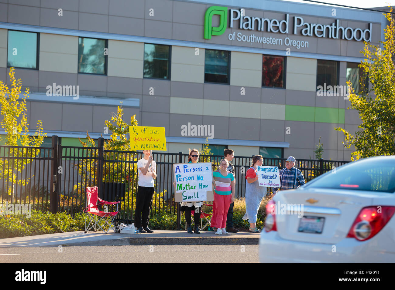 Anti-abortion protesters target pedestrian and vehicle passersby in front of Planned Parenthood of Stock Photo