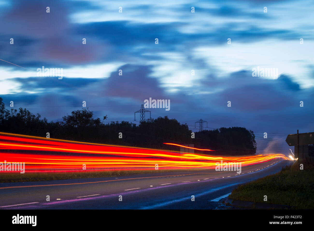 Billingham, UK. 14th October, 2015. UK Weather: light trails of cars and fuel tankers in pre dawn light on the Seal Sands road on a chilly morning in Billingham. The road leads to the enormous Seal Sands petro - chemical complex at the mouth of the river Tees Credit:  Alan Dawson News/Alamy Live News Stock Photo