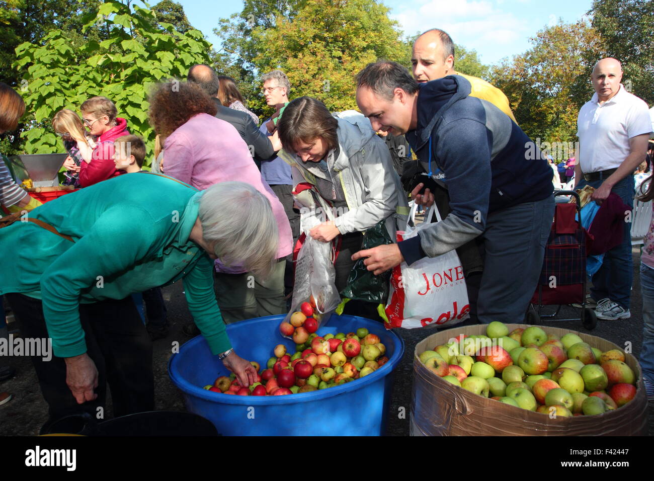 People bring apples for pressing into juice at a community Apple Day event in Sheffield, South Yorkshire England Stock Photo