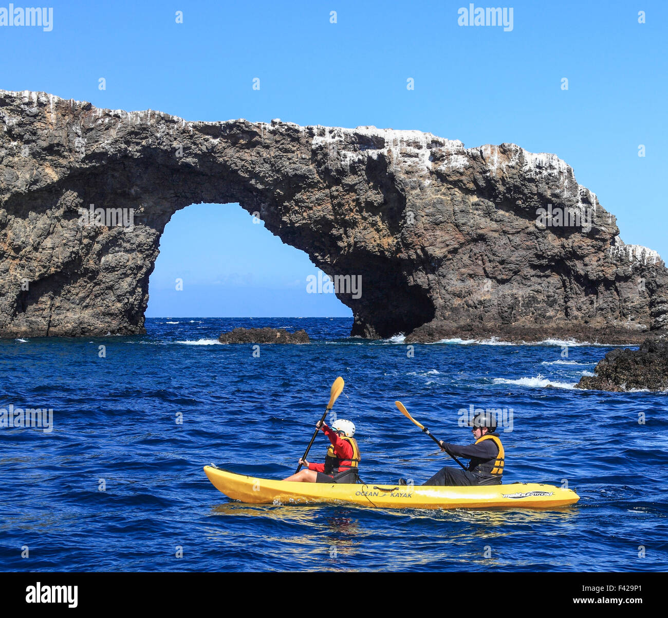 Kayakers paddle near Arch Rock at Channel Islands National Park Stock Photo