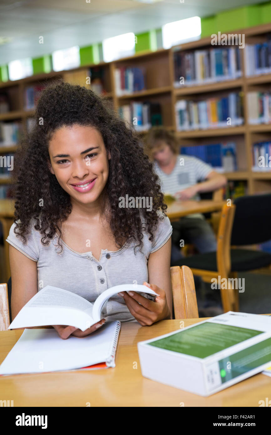 Student studying in the library Stock Photo - Alamy