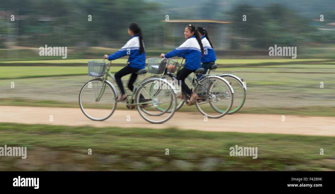 school girls cycling nr Phong Nha, Quảng Bình Province, Vietnam Stock Photo