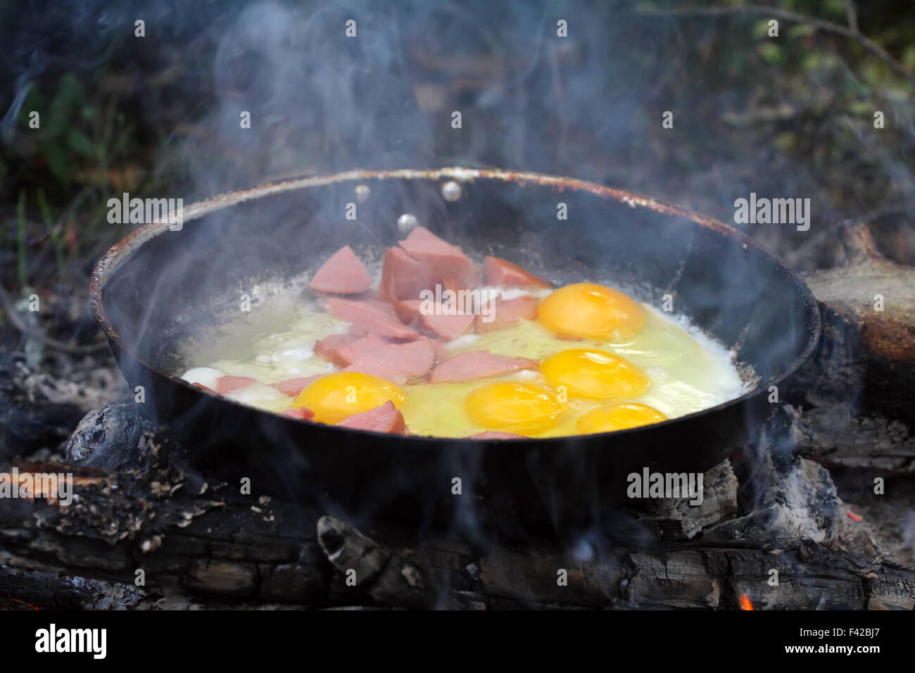 An unusual way of cooking eggs on fire Stock Photo Alamy
