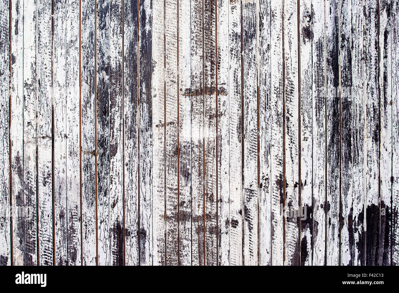 Old rustic wooden plank wall painted white, paint peel texture Stock Photo
