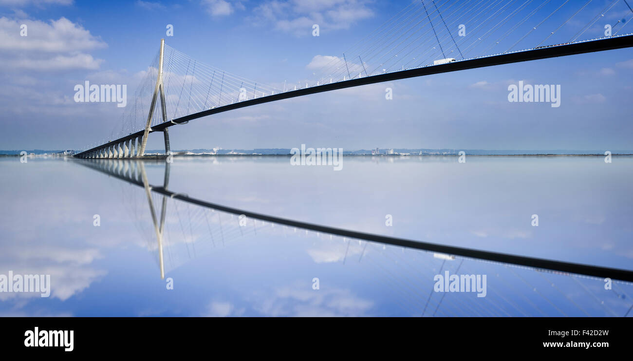 pillar of the bridge 'Pont du Normandie' reflected in the Seine river at Le Havre, France Stock Photo