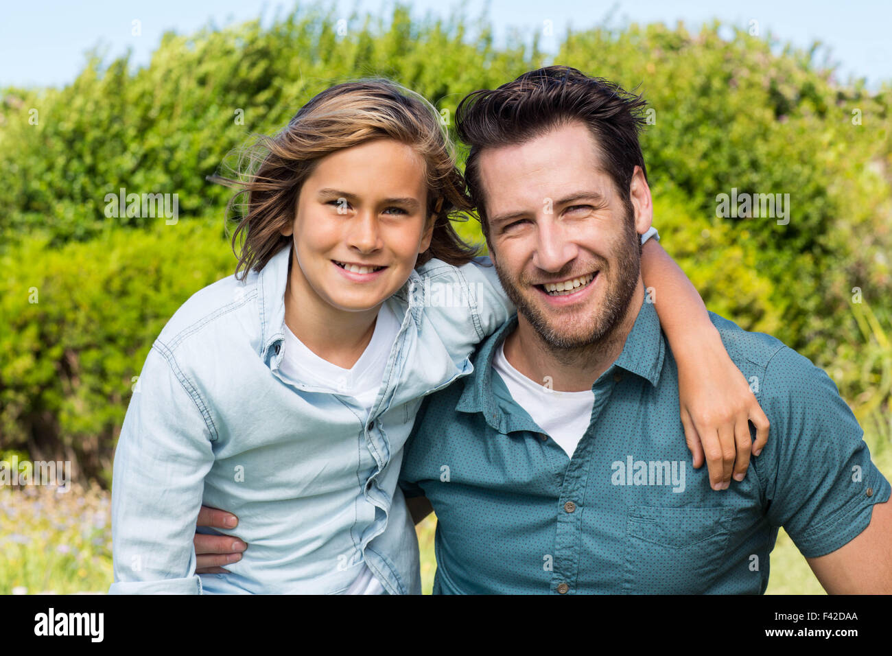Father and son smiling at camera Stock Photo - Alamy