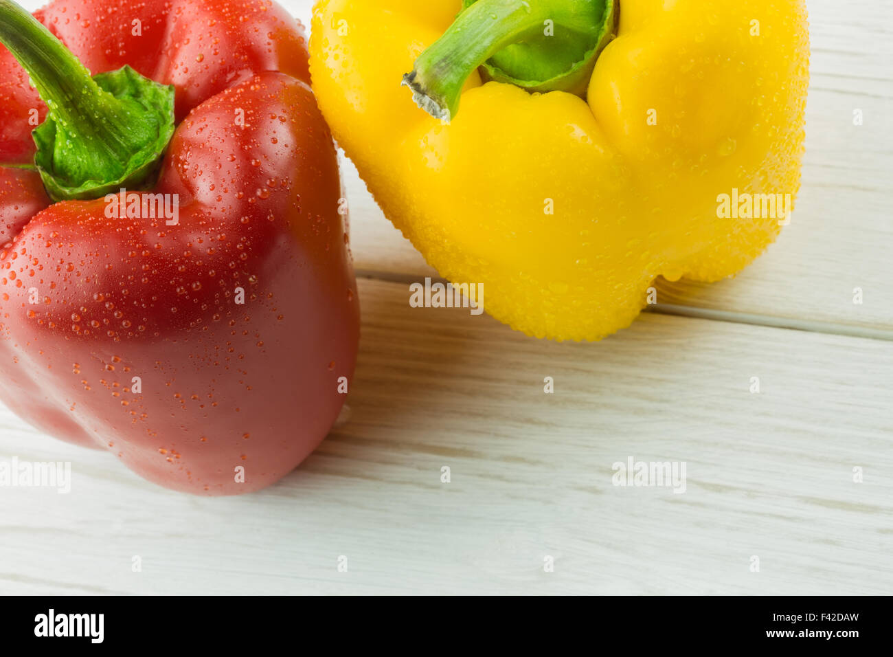 Two peppers on chopping board Stock Photo - Alamy