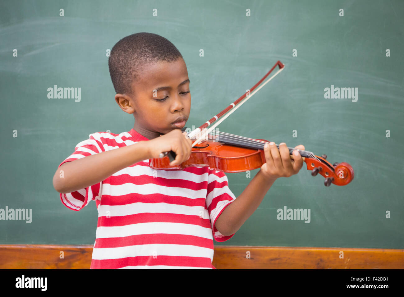 Cute pupil playing violin in classroom Stock Photo - Alamy