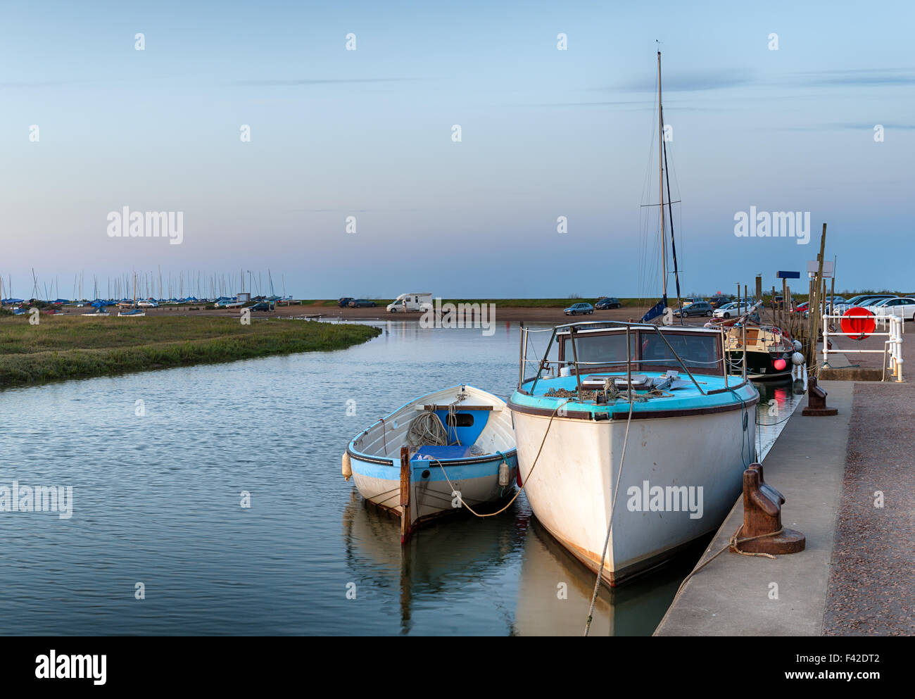 Boats moored at the quay at Blakeney on the Norfolk coast Stock Photo