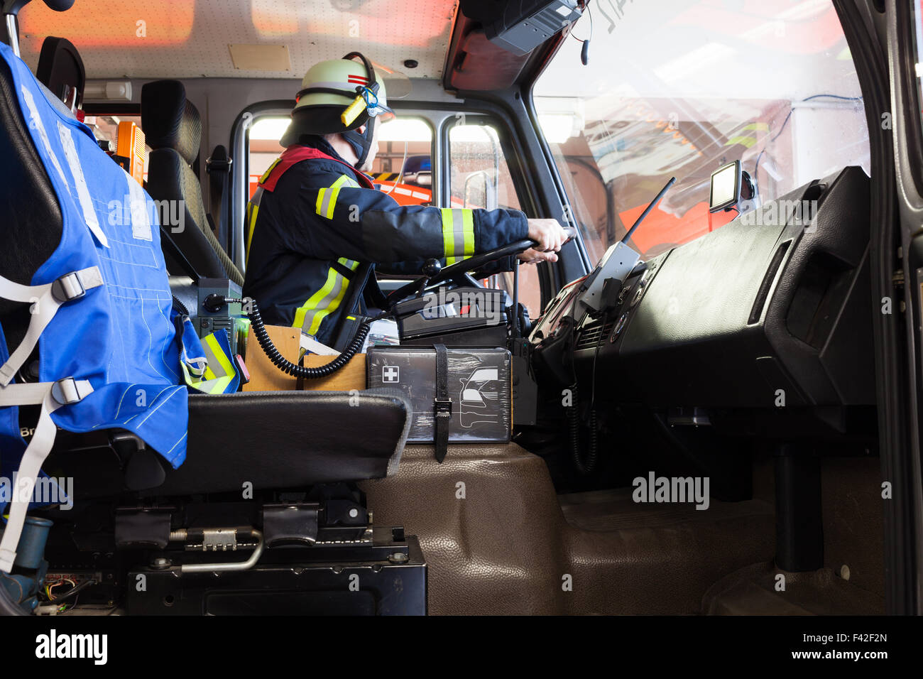 Firefighter driving a used fire truck Stock Photo