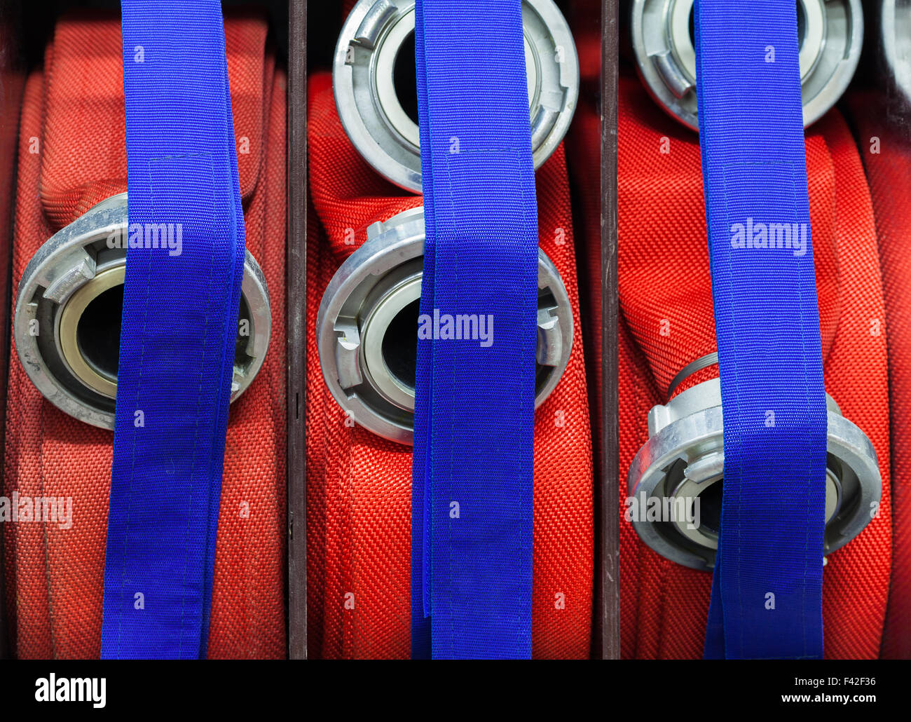 Fire department hoses coiled with strap Stock Photo