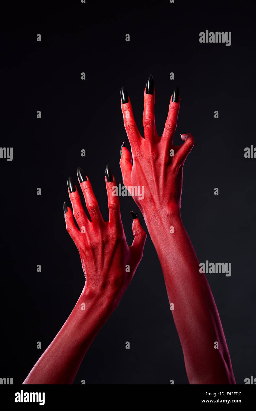 Red Devil Hands With Black Nails Reaching Out Halloween Theme Stock Photo Alamy