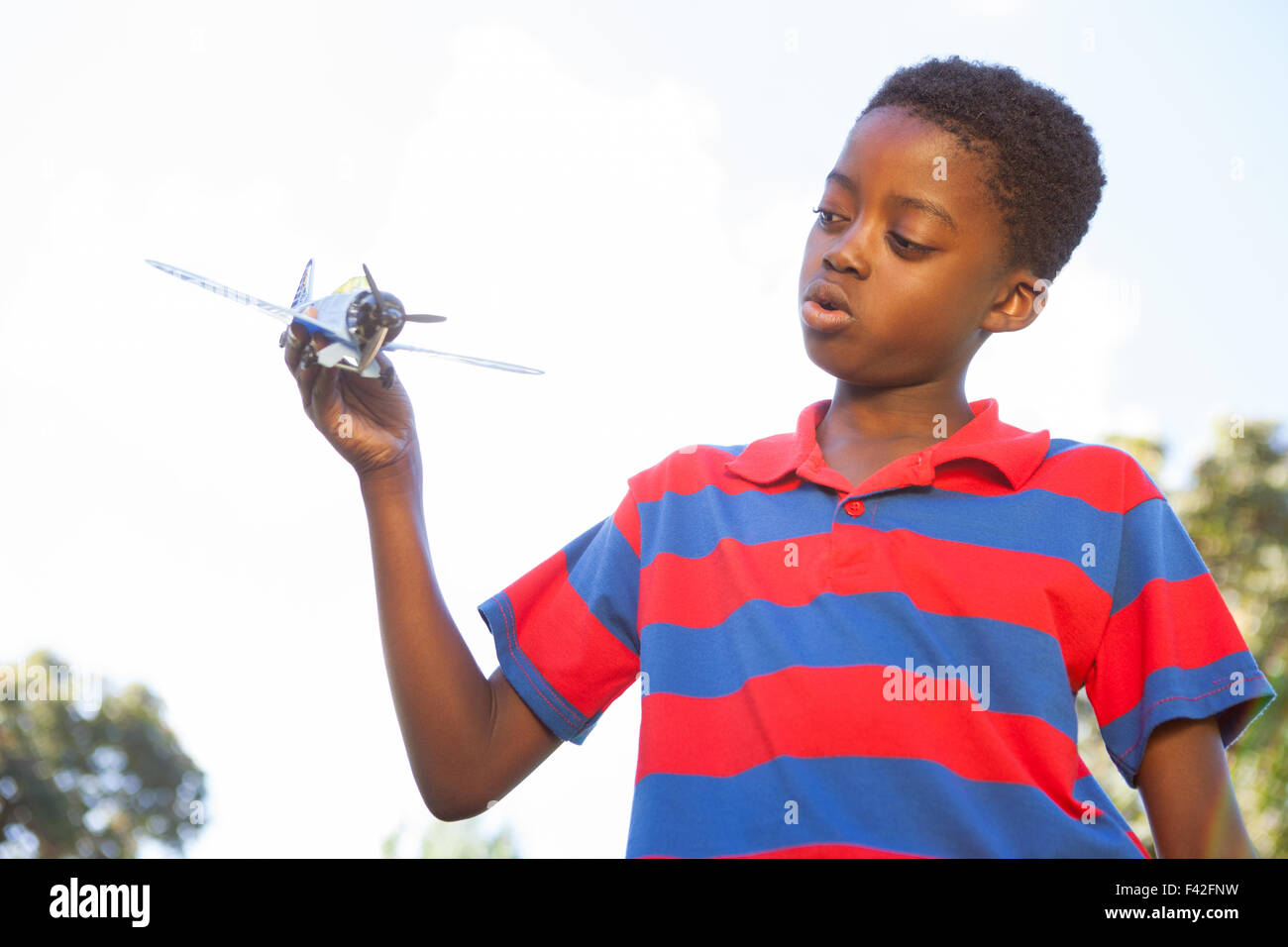 Little boy playing with toy airplane Stock Photo - Alamy