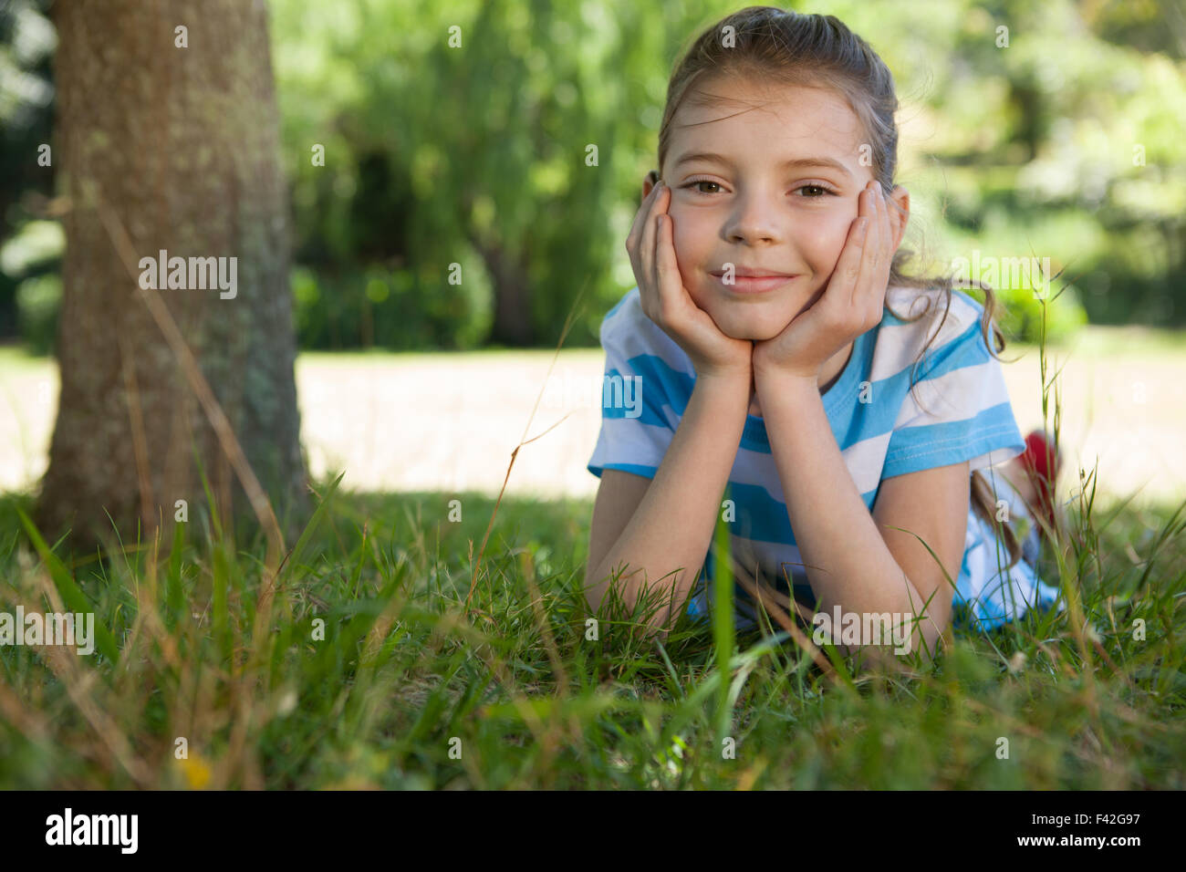 Cute little girl smiling at camera Stock Photo - Alamy