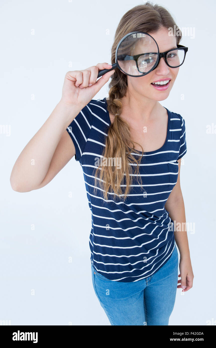 Smiling woman holding magnifying glass Stock Photo - Alamy