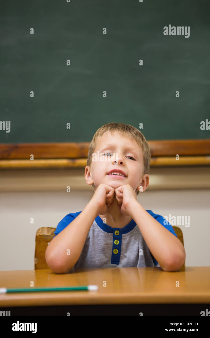 Smiling pupil sitting at his desk Stock Photo - Alamy